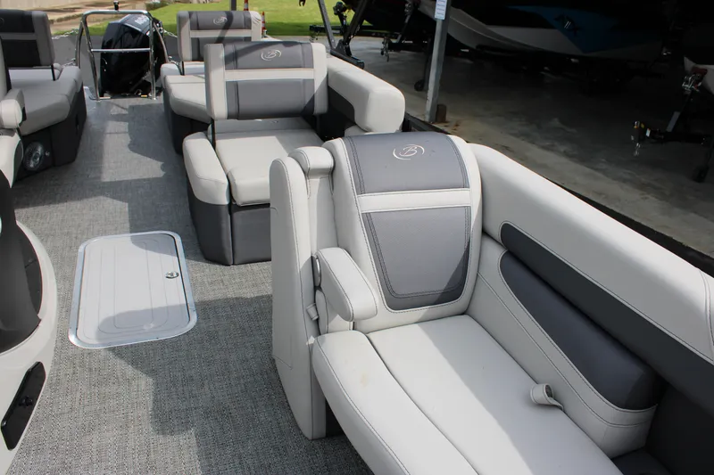 Slide: The Image of 2025 Barletta Cabrio 22M pontoon boat interior with gray seating and carpeted flooring. - 11