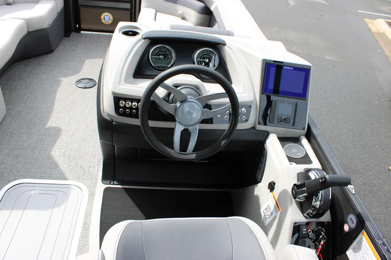 Slide: The Image of 2025 Barletta Cabrio 22M boat dashboard with steering wheel and digital display. - 12