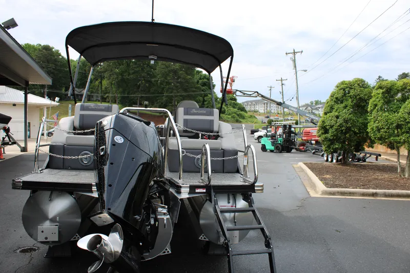 Slide: The Image of 2025 Barletta Cabrio 22M pontoon boat with outboard motor, parked outdoors. - 4