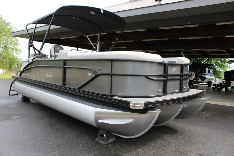 Slide: The Image of 2025 Barletta Cabrio 22M pontoon boat with canopy, parked on pavement. - 8