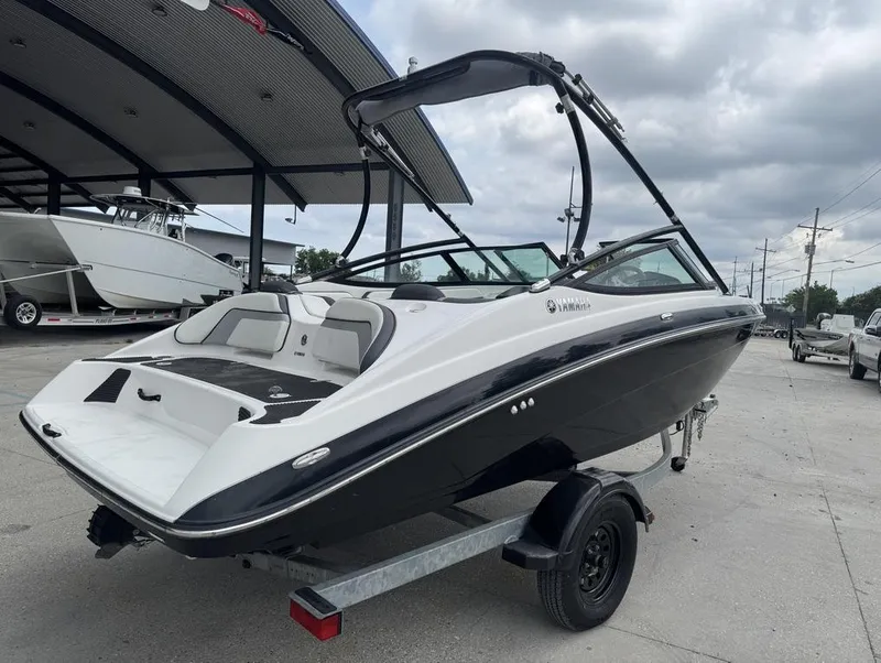 Slide: The Image of 2015 Yamaha AR190 boat on trailer, parked outdoors under cloudy sky. - 12