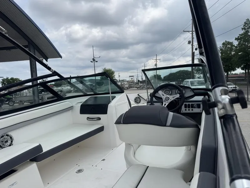 Slide: The Image of 2015 Yamaha Boats AR190 interior with steering wheel and seating under cloudy sky. - 14
