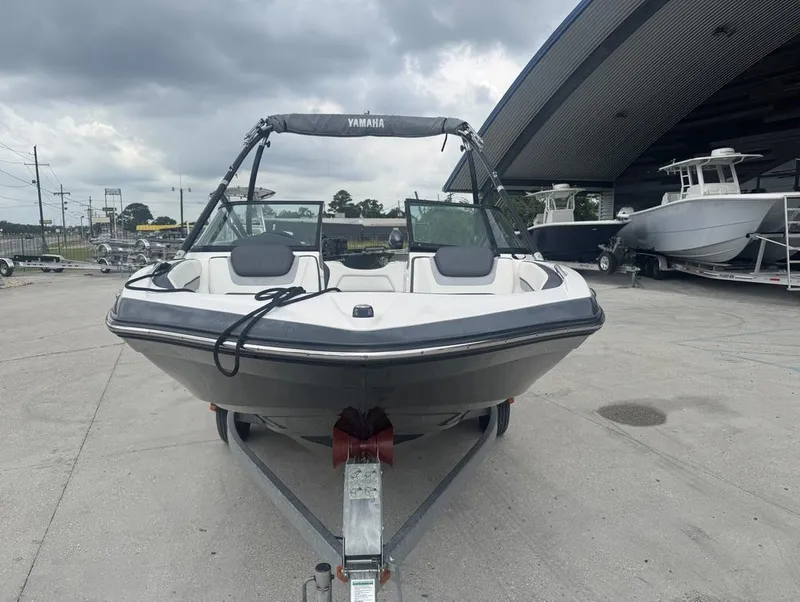 Slide: The Image of 2015 Yamaha AR190 boat on trailer, parked outdoors under cloudy sky. - 5