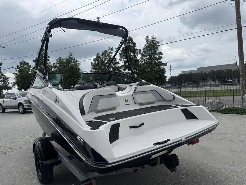 Slide: The Image of 2015 Yamaha AR190 boat on trailer, parked outdoors under cloudy sky. - 6