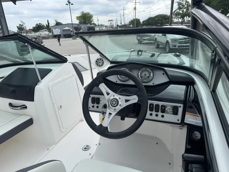 Slide: The Image of 2015 Yamaha Boats AR190 cockpit with steering wheel and dashboard controls. - 8