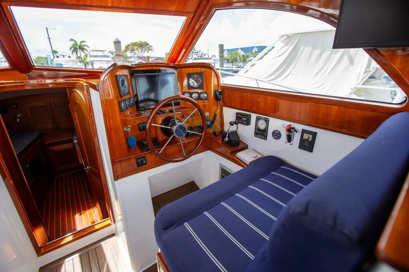 Slide: The Image of Luxurious 2003 San Juan SJ 38 yacht interior with wooden helm and blue seating. - 15