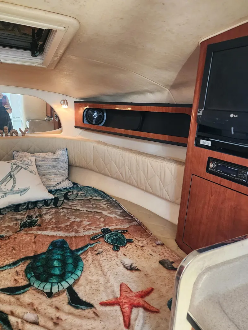 Slide: The Image of Interior of 2007 Sea Ray 280 Sundancer with cozy bedding and entertainment system. - 11