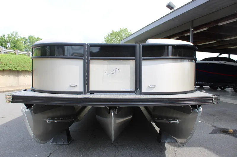 Slide: The Image of 2025 Barletta Aria 24QC pontoon boat, front view, parked outdoors. - 14