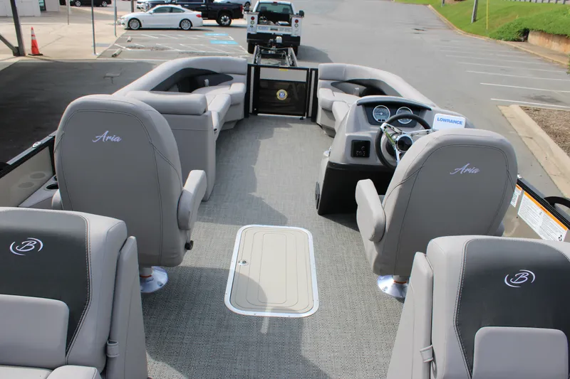 Slide: The Image of 2025 Barletta Aria 24QC pontoon boat interior with gray seating and modern dashboard. - 16