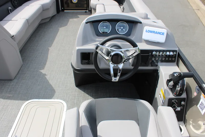 Slide: The Image of 2025 Barletta Aria 24QC boat interior with steering wheel and control panel. - 18
