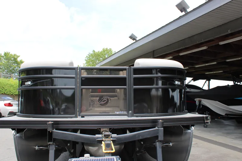 Slide: The Image of 2025 Barletta Corsa 23UC pontoon boat rear view at a marina. - 13