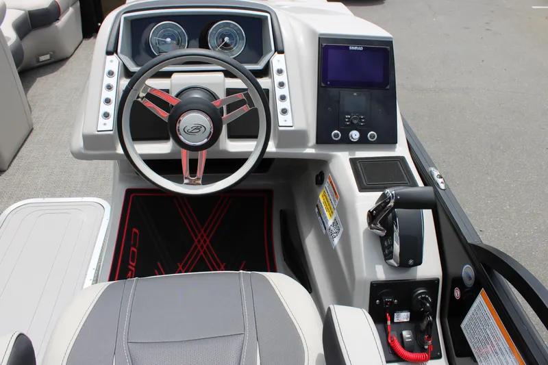 Slide: The Image of 2025 Barletta Corsa 23UC boat dashboard with steering wheel and control panel. - 21