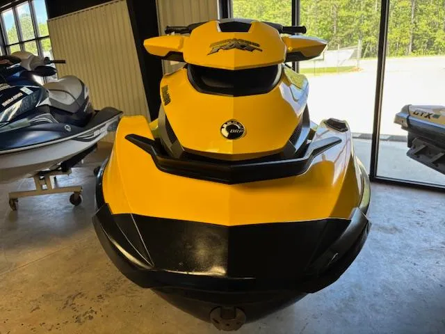 Slide: The Image of 2009 Sea-Doo RXT iS 255 jet ski, yellow and black, displayed indoors. - 2