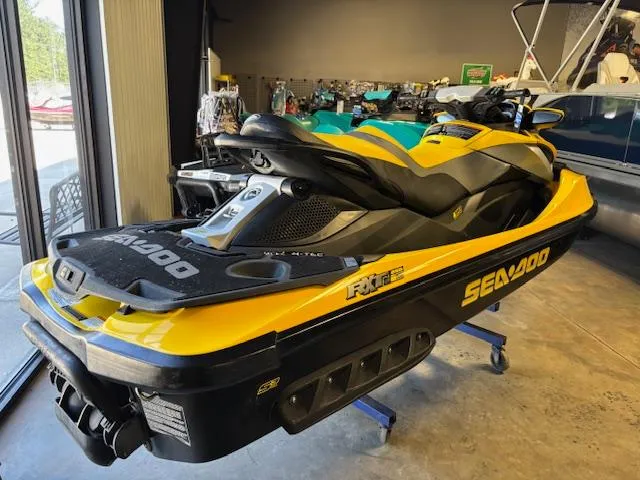 Slide: The Image of 2009 Sea-Doo RXT iS 255 jet ski in a showroom, yellow and black design. - 5