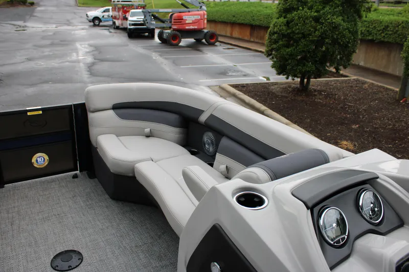 Slide: The Image of 2025 Barletta Cabrio 22QC boat interior with plush seating and modern dashboard. - 13