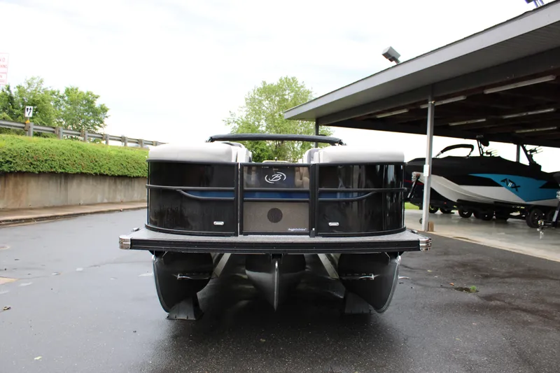 Slide: The Image of 2025 Barletta Cabrio 22QC pontoon boat parked on wet pavement. - 14