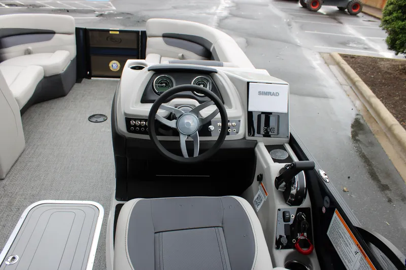 Slide: The Image of 2025 Barletta Cabrio 22QC boat interior with steering wheel and control panel. - 6