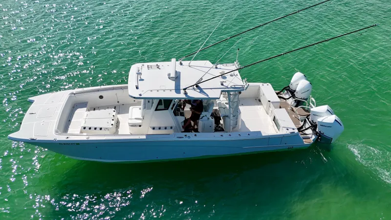 Slide: The Image of 2022 World Cat 400 CC-X boat on clear green water, aerial view. - 10