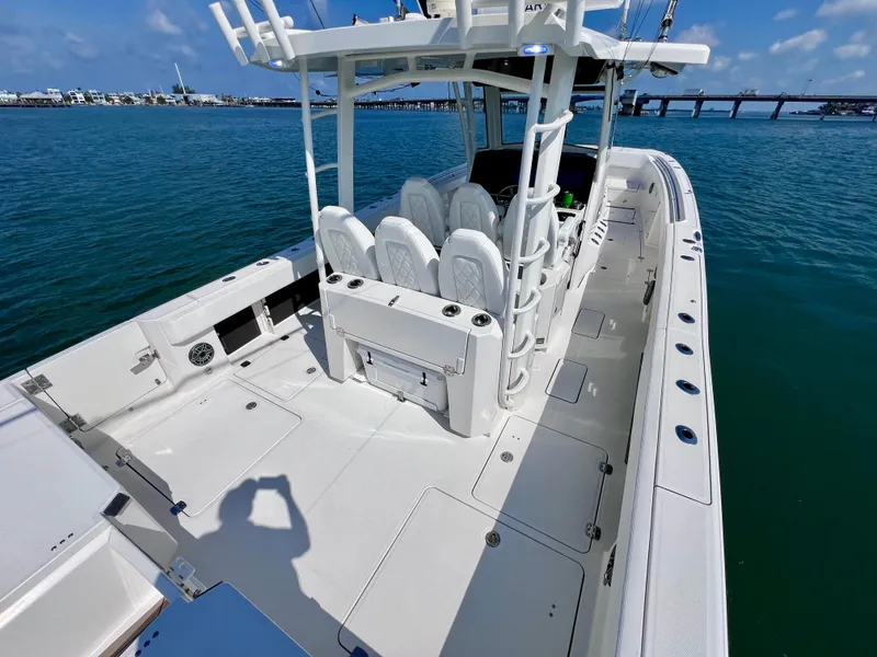 Slide: The Image of 2022 World Cat 400 CC-X boat on water, featuring spacious deck and seating. - 14