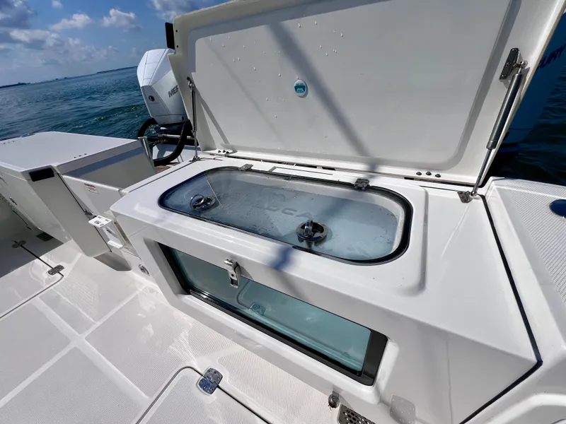 Slide: The Image of 2022 World Cat 400 CC-X boat with open storage compartment on deck. - 18