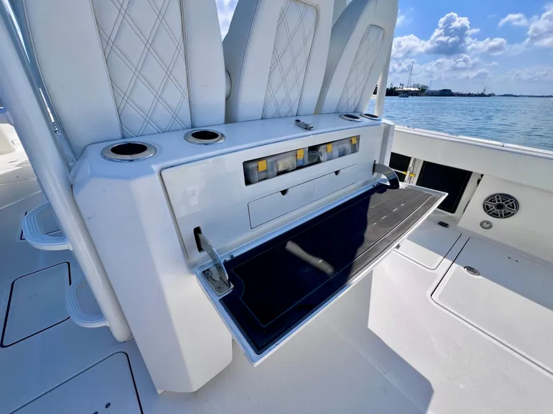 Slide: The Image of Luxury boat interior with fold-out table, cup holders, and seating. World Cat 400 CC-X 2022 model. - 23