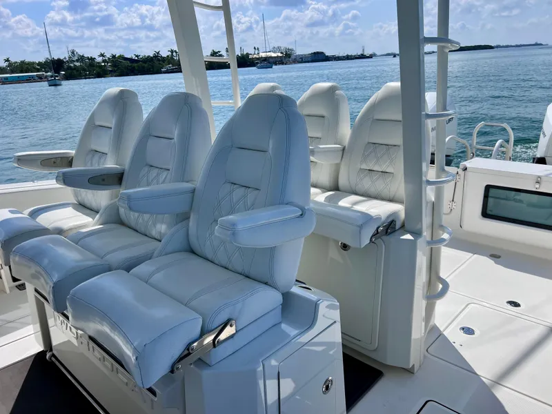Slide: The Image of Luxurious seating on 2022 World Cat 400 CC-X boat, featuring joystick controls and night vision. - 26