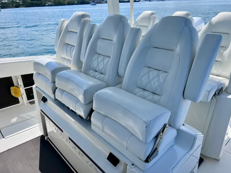 Slide: The Image of Luxurious seating on 2022 World Cat 400 CC-X boat, featuring plush white leather upholstery. - 28