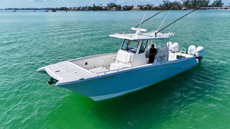 Slide: The Image of 2022 World Cat 400 CC-X boat on clear turquoise water, featuring quad engines and joystick control. - 3