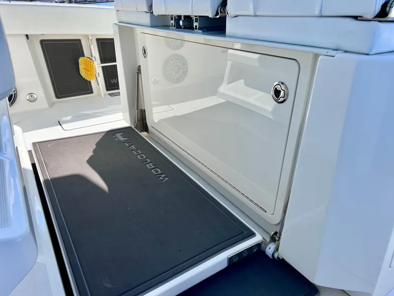 Slide: The Image of 2022 World Cat 400 CC-X boat interior with storage compartment and non-slip mat. - 30