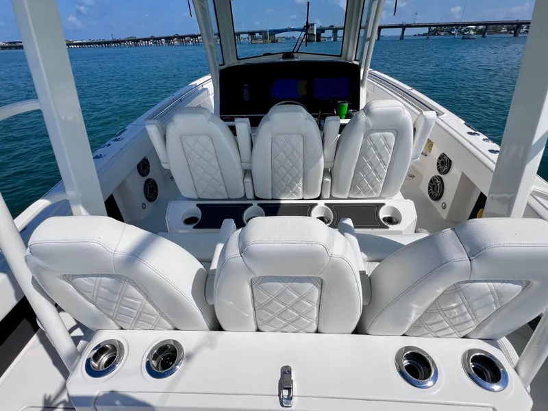 Slide: The Image of Luxury interior of 2022 World Cat 400 CC-X boat with white seating and joystick controls. - 33