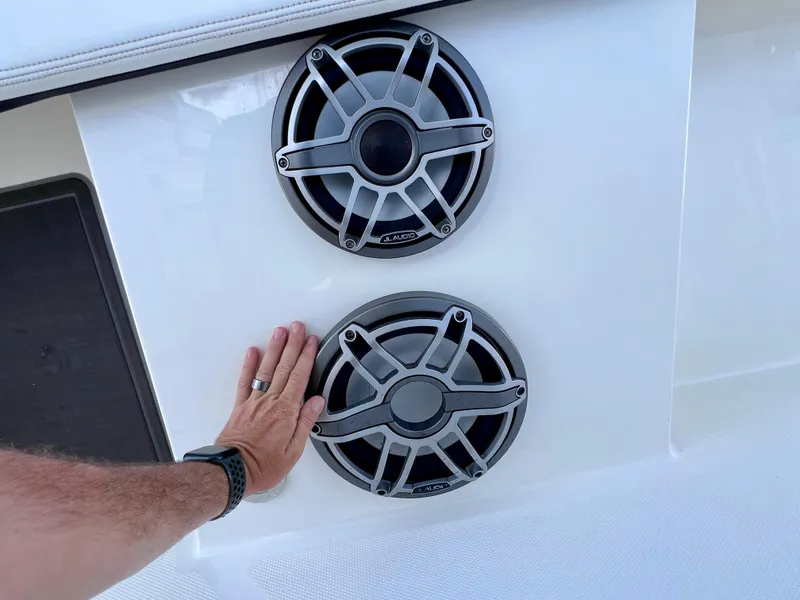 Slide: The Image of Hand touching dual speakers on 2022 World Cat 400 CC-X boat. - 35