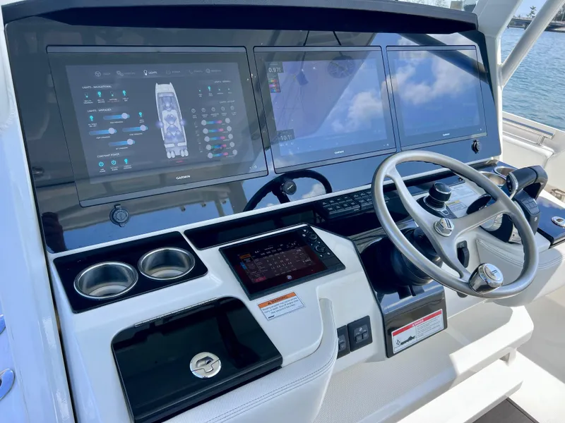 Slide: The Image of 2022 World Cat 400 CC-X boat dashboard with joystick, night vision, and advanced controls. - 43