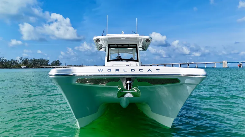 Slide: The Image of 2022 World Cat 400 CC-X boat on clear turquoise water under blue sky. - 6