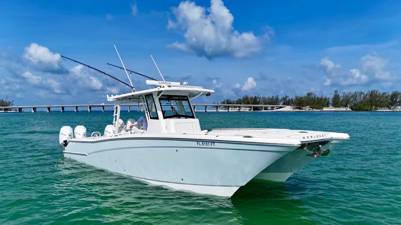 Slide: The Image of 2022 World Cat 400 CC-X boat on clear water under blue sky. - 7