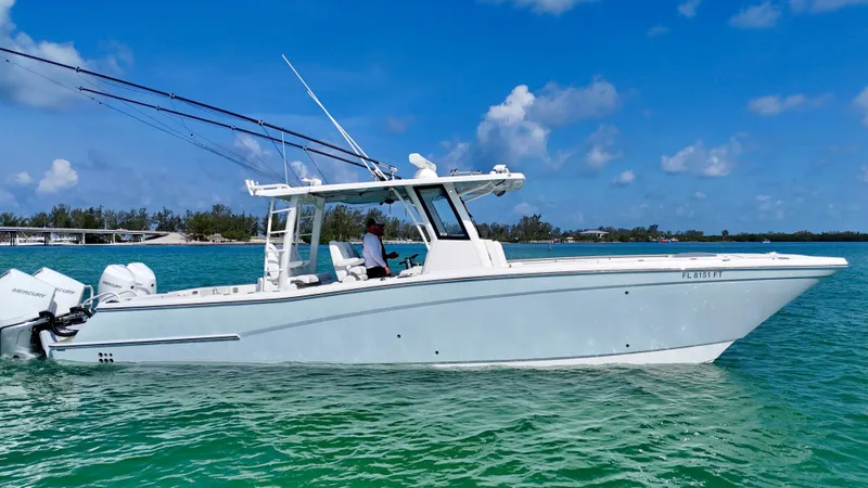 Slide: The Image of 2022 World Cat 400 CC-X boat on clear water, featuring quad engines and joystick control. - 8