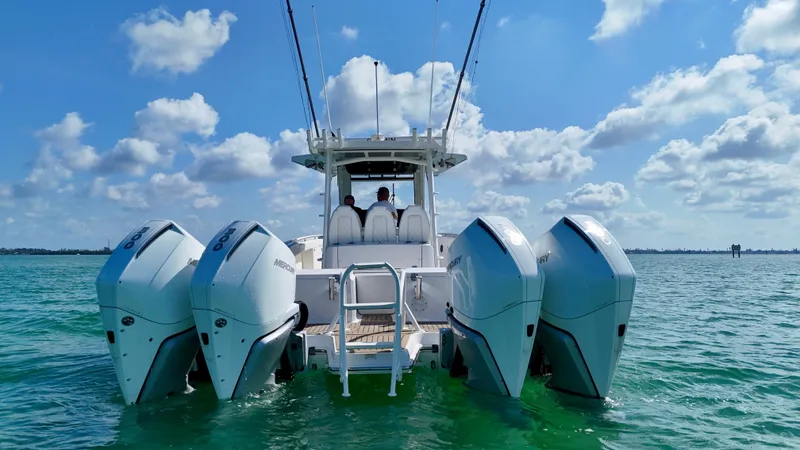 Slide: The Image of 2022 World Cat 400 CC-X boat with quad engines on open water under blue sky. - 9