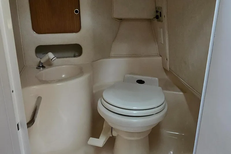 Slide: The Image of 1999 Sea Ray 280 SS boat bathroom with toilet and sink. - 14