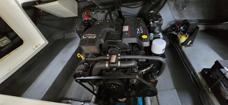 Slide: The Image of 1999 Sea Ray 280 SS engine compartment with V8 motor, showcasing mechanical components. - 20