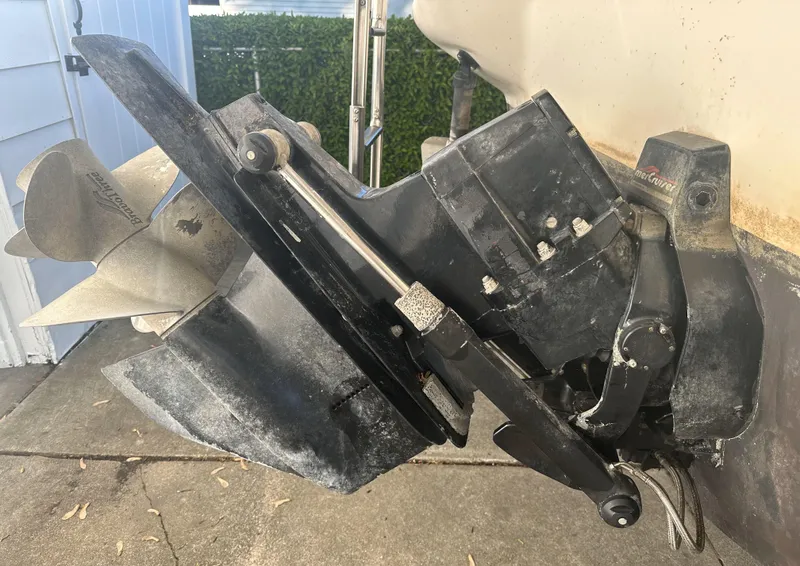 Slide: The Image of 1999 Sea Ray 280 SS boat outdrive and propeller on a concrete surface. - 22