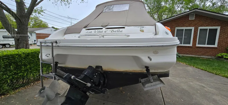 Slide: The Image of 1999 Sea Ray 280 SS boat parked in driveway, rear view with cover. - 5
