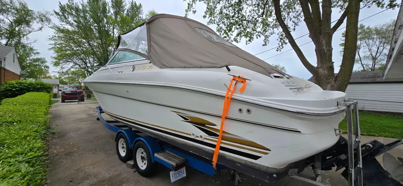 Slide: The Image of 1999 Sea Ray 280 SS boat on trailer, covered and parked in driveway. - 6