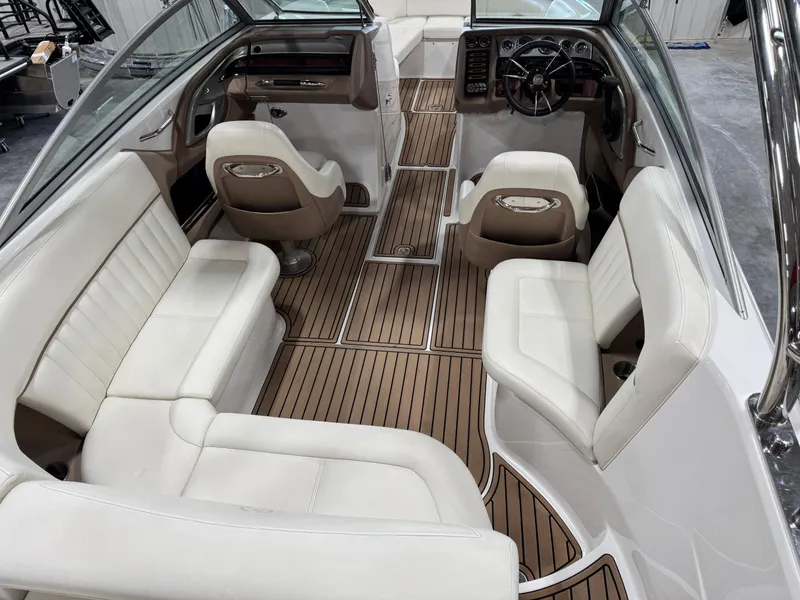 Slide: The Image of 2007 Cobalt 272 BR boat interior with white seating and wood flooring. - 11