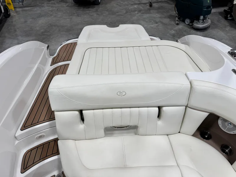 Slide: The Image of 2007 Cobalt 272 BR boat interior with white leather seating and wood accents. - 12
