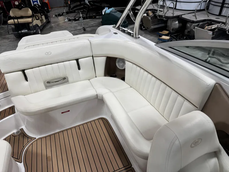 Slide: The Image of 2007 Cobalt 272 BR boat interior with white leather seating and wood flooring. - 13