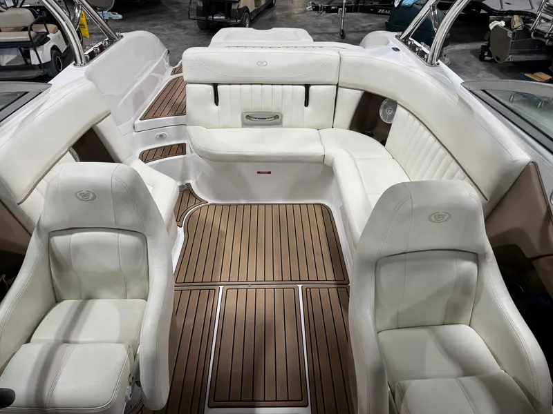 Slide: The Image of 2007 Cobalt 272 BR boat interior with white seating and wooden flooring. - 14
