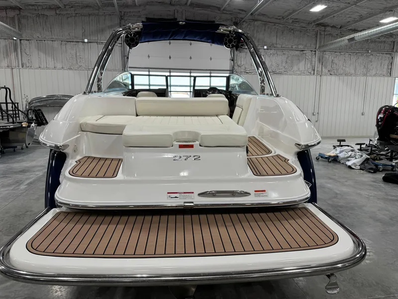 Slide: The Image of 2007 Cobalt 272 BR boat with teak swim platform in a spacious indoor setting. - 5