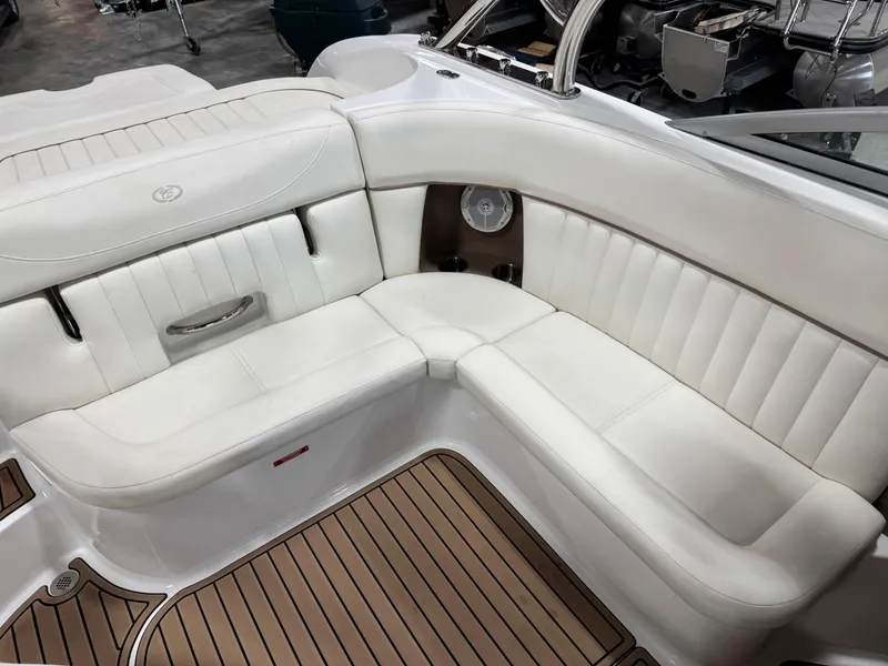 Slide: The Image of 2007 Cobalt 272 BR boat interior with white leather seating and wood flooring. - 6