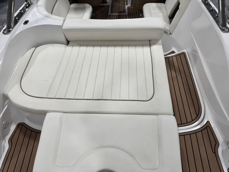 Slide: The Image of 2007 Cobalt 272 BR boat interior with white seating and wood-style flooring. - 9