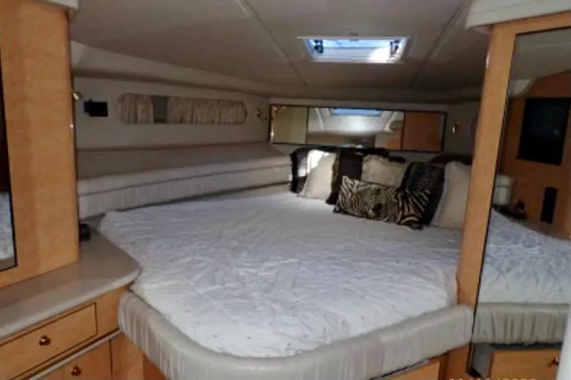 Slide: The Image of Luxurious cabin interior of 1998 Sea Ray 500 Sundancer yacht with plush bedding. - 7