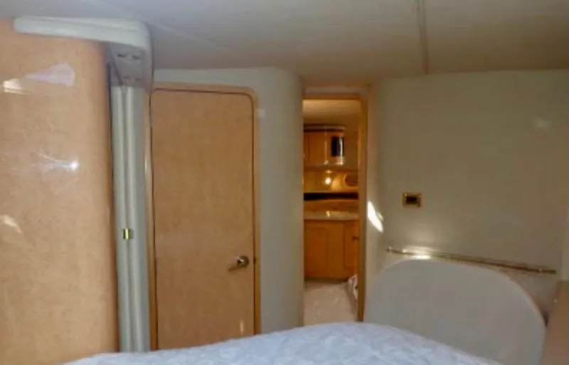 Slide: The Image of Interior of 1998 Sea Ray 500 Sundancer yacht, featuring a cozy cabin and wooden door. - 8